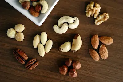 A variety of nuts and nut products are arranged on a table.