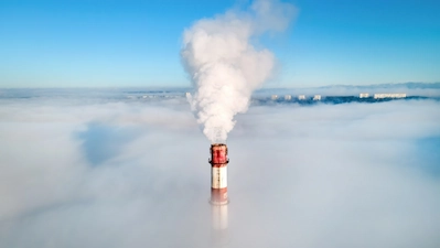 View from above shows a chimney with smoke rising into the air - air quality testing